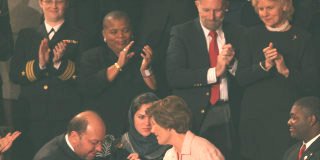 Hamid Gilani, vice-president of Afghan senate, kisses the hand of Laura Bush