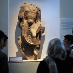 Afghan students look at a damaged statue ©AFP/Getty Images