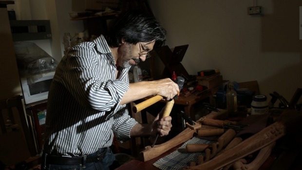 Afghan refugee and craftsman Hashmat Shafaq working on a table leg in his store Rosewood Furniture in Woden. He was a woodworker in Afghanistan before he came to Australia in 1999. Photo: Jeffrey Chan